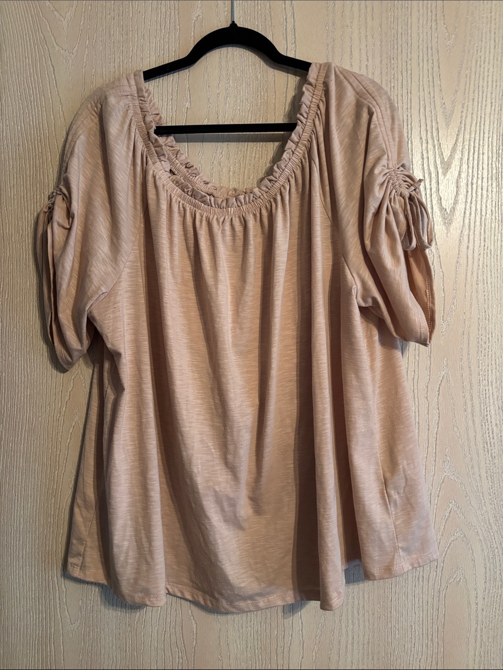 Tan off shoulder blouse with ruched scooped neckline and tie detailed sleeves